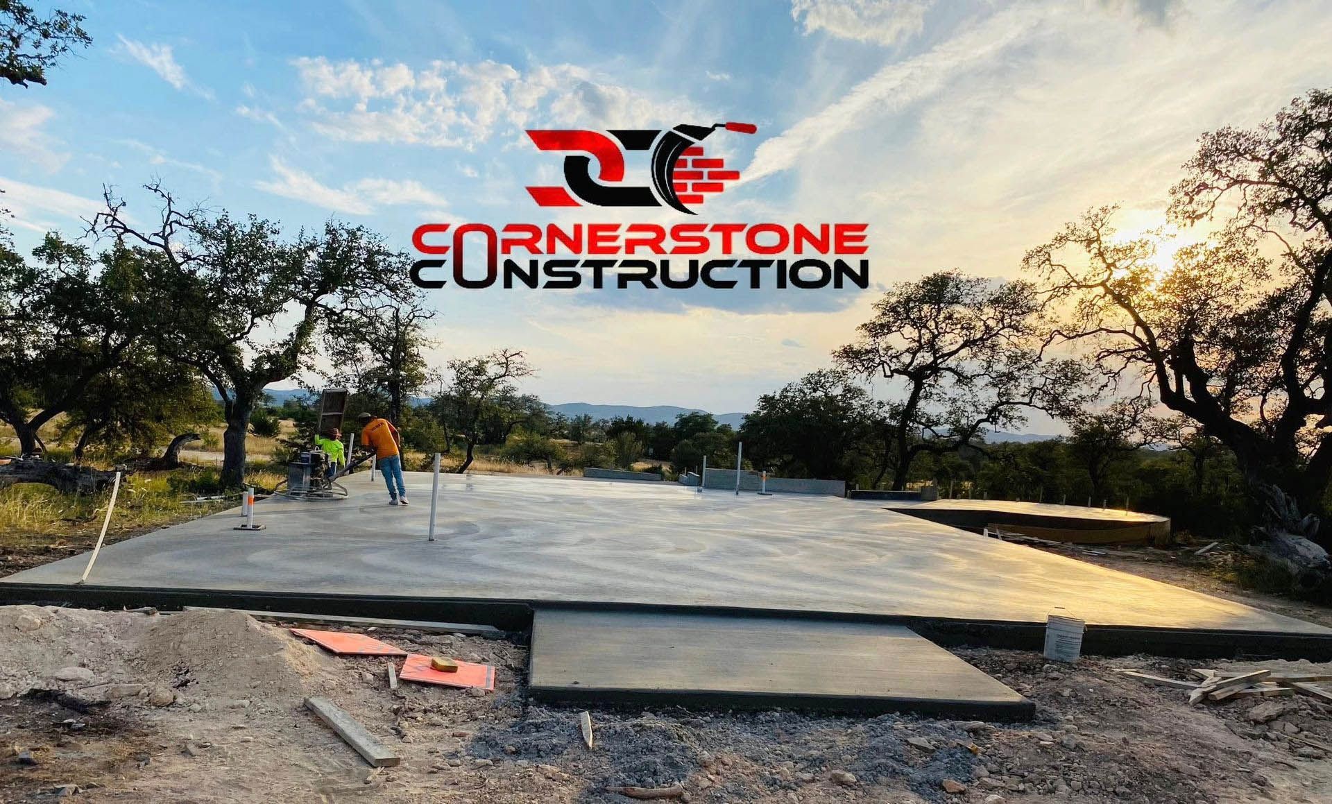 Concrete pathway with curb, leading through a grassy area toward trees