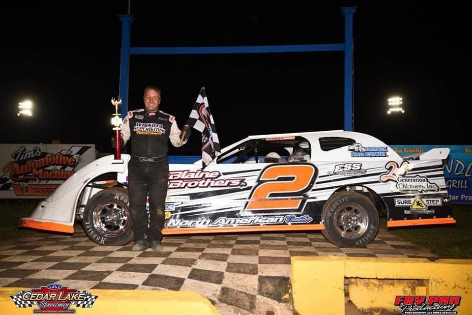 Blue shock absorber top with “PROOF” and “TAMPER” markings, sitting on a metal surface.