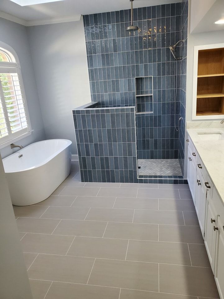 A bathroom with a bathtub and a walk in shower.