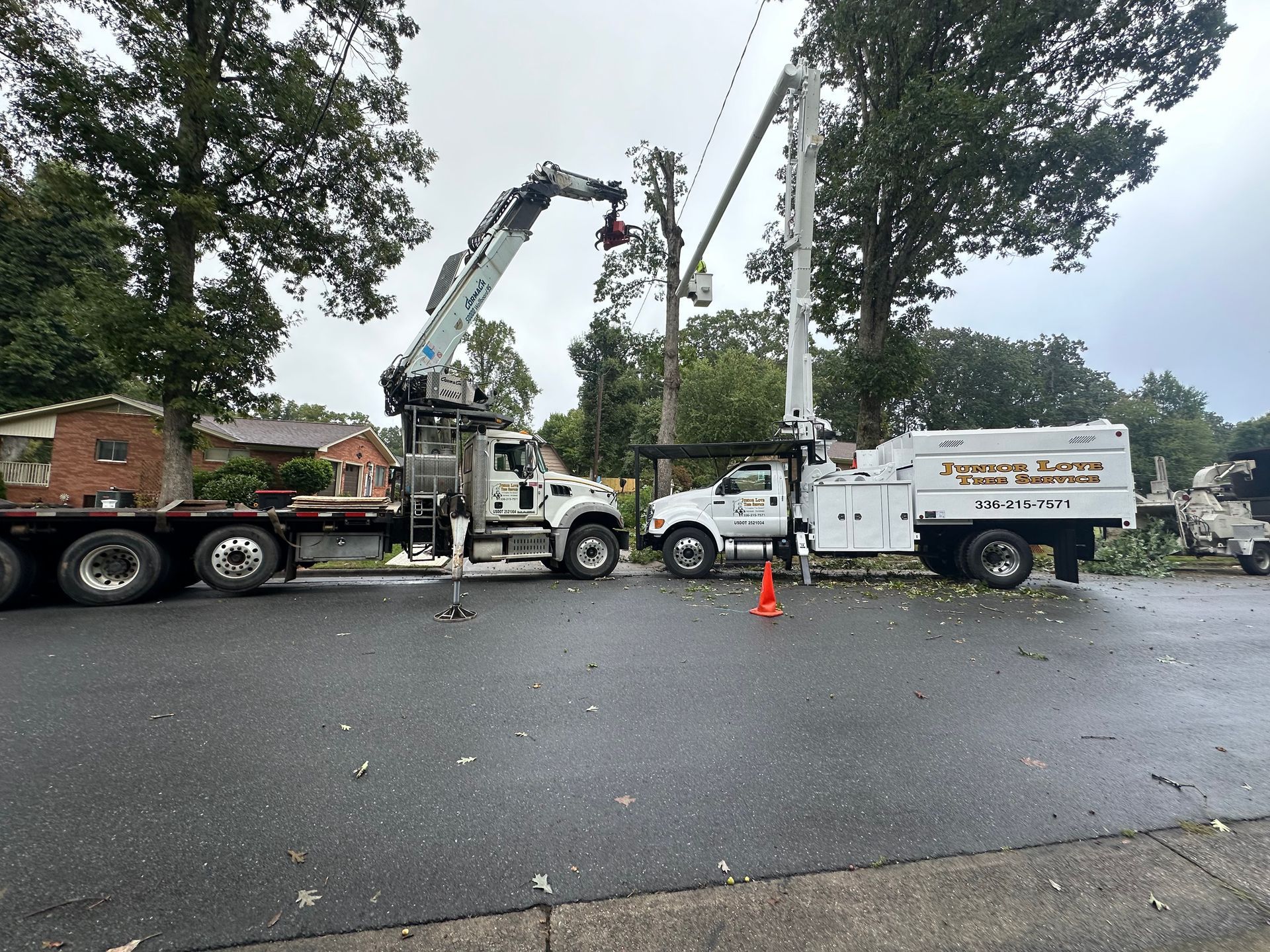 A couple of trucks are parked on the side of the road.