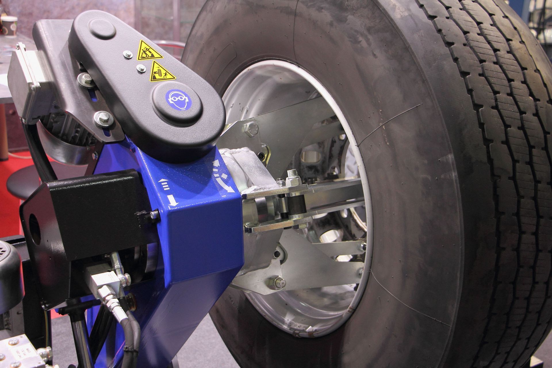 Blue wheel alignment machine measuring a car tire in a garage