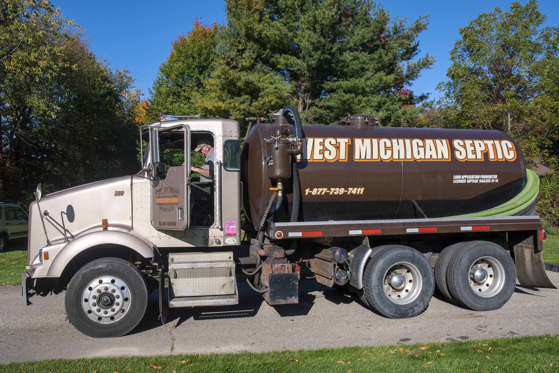 Tan West Michigan Septic truck with a brown tank.