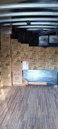 A warehouse filled with lots of boxes and a table.