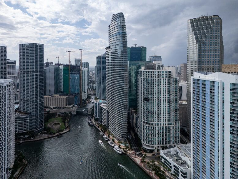 High-rise waterfront condos lining a canal in a modern city skyline