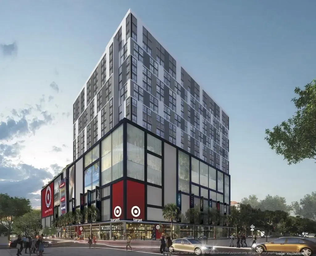 Modern multi-story commercial building with glass ground floor and patterned upper facade at a city street corner