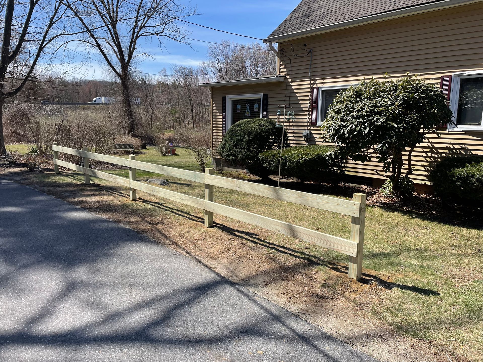 There is a wooden fence in front of a house.