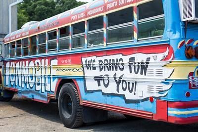 A colorful, multi-toned blue school bus painted with 