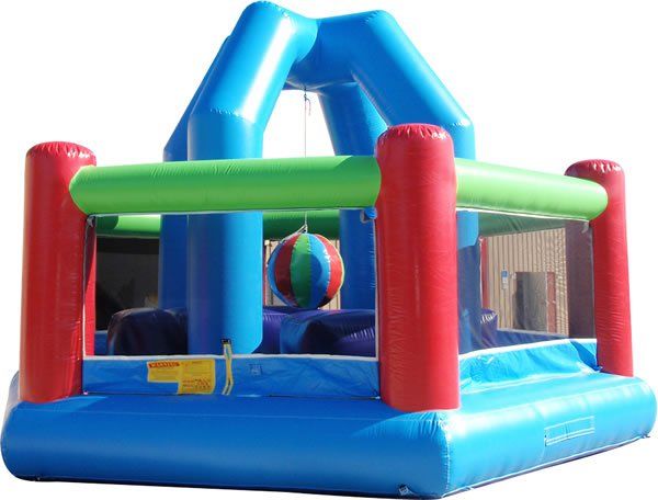 A colorful inflatable bounce house with a central hanging ball for a floating ball game.