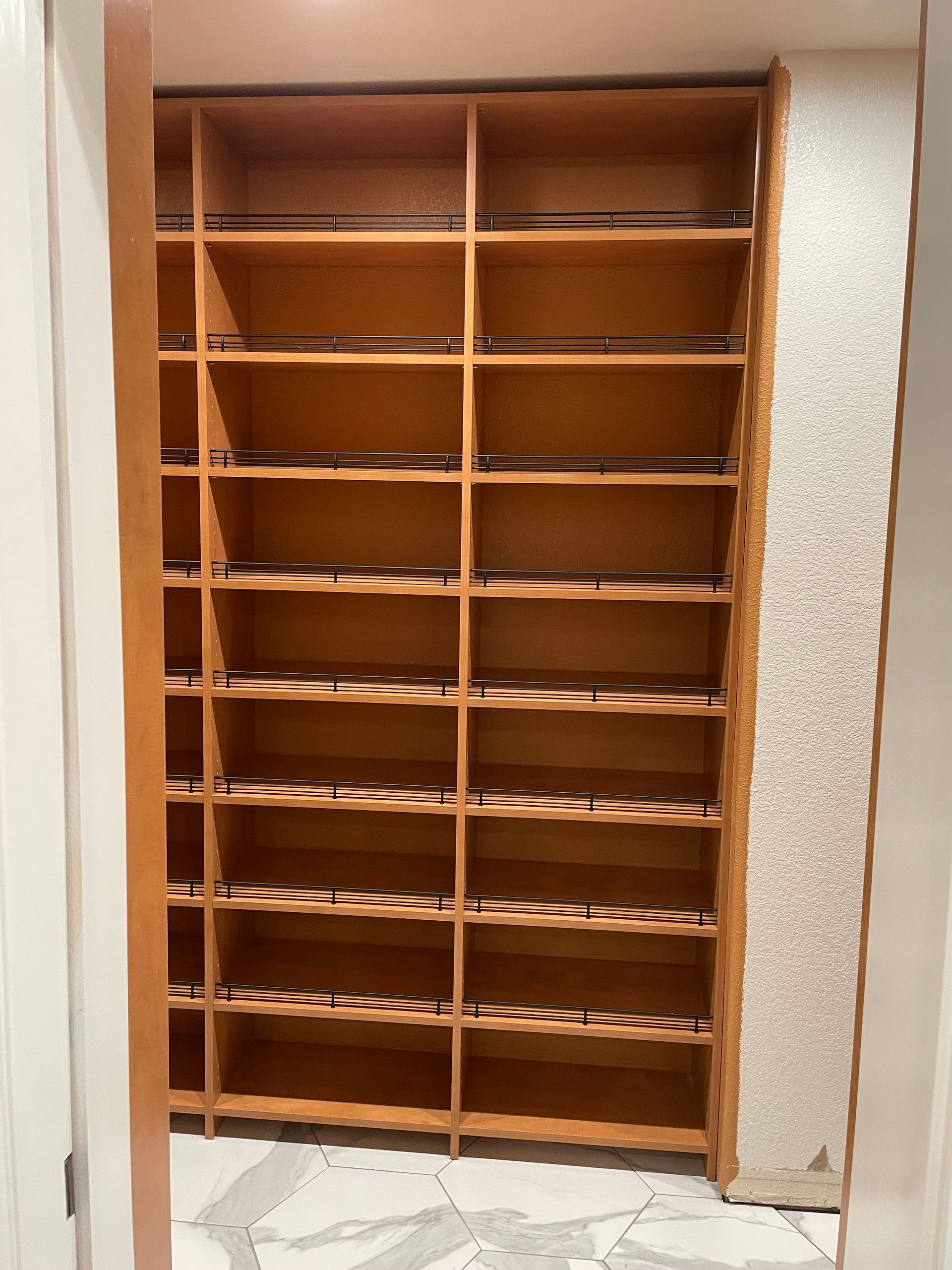 A closet with lots of shelves and a door