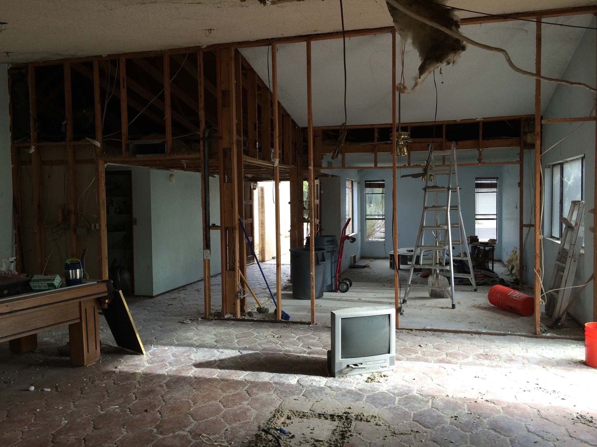 A television sits in the middle of a room that is being remodeled