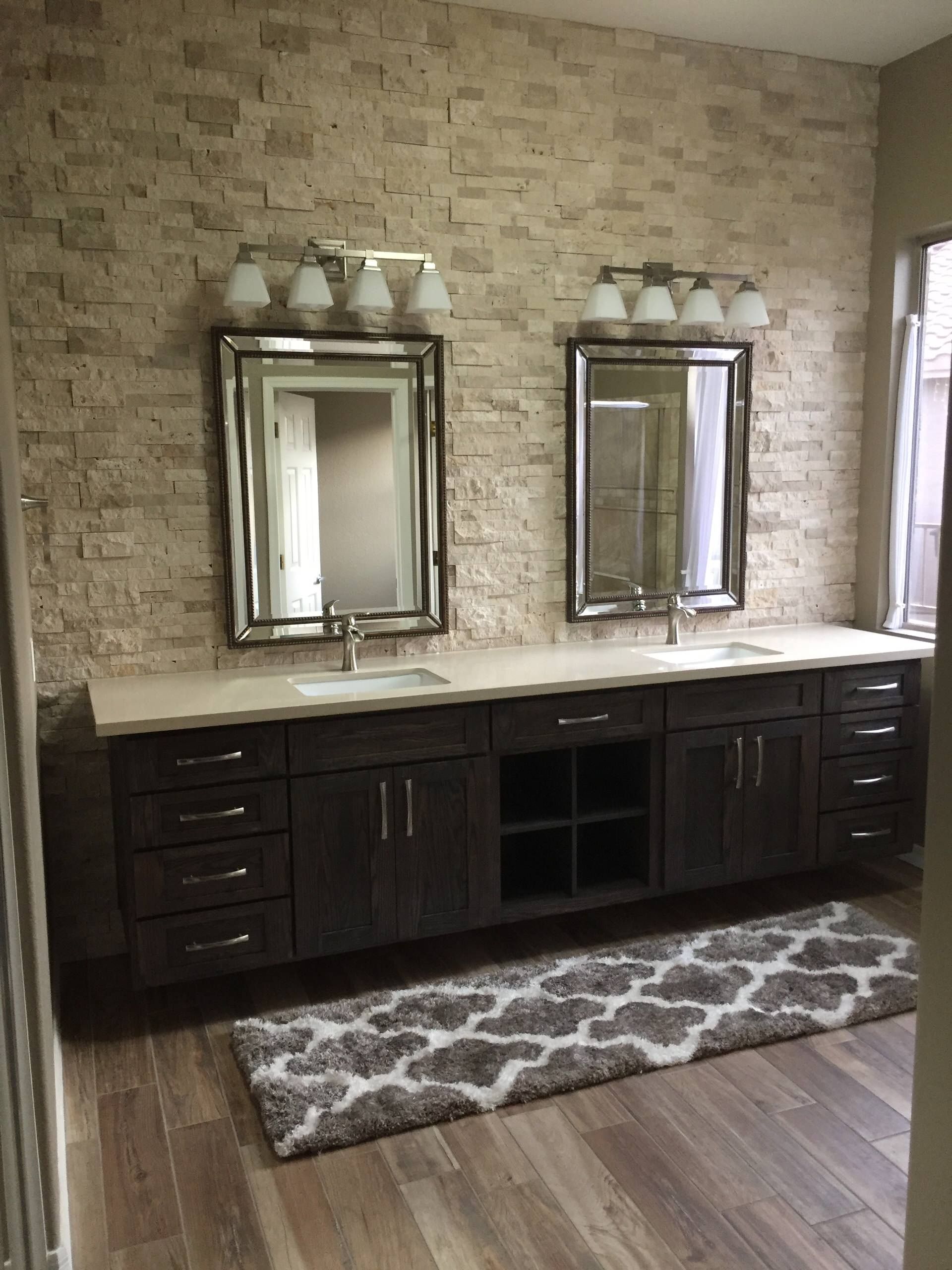 A bathroom with two sinks and two mirrors