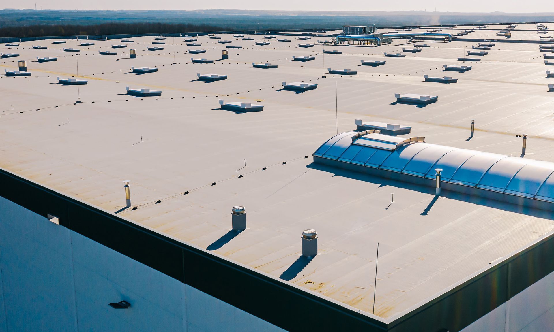 An aerial view of a large building with a lot of planes on the roof.