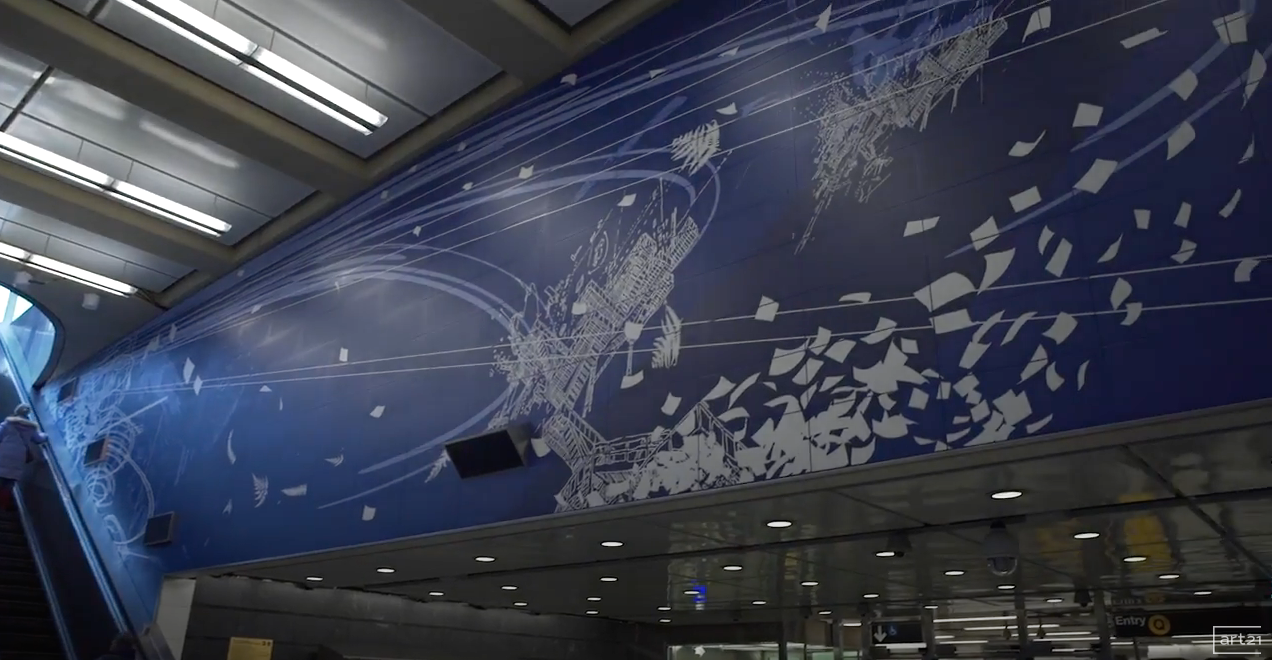 Blue airport mural with white abstract bird and geometric patterns above a terminal walkway
