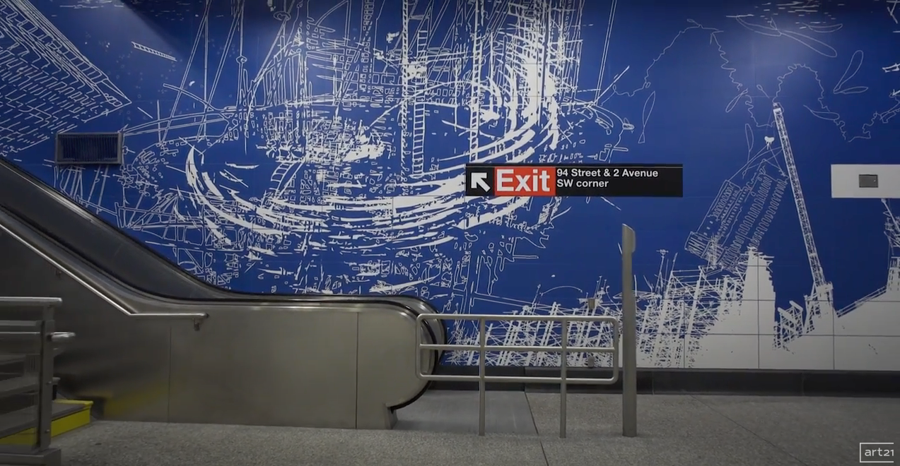 Empty subway station platform with blue wall mural, stairs, and an exit sign.