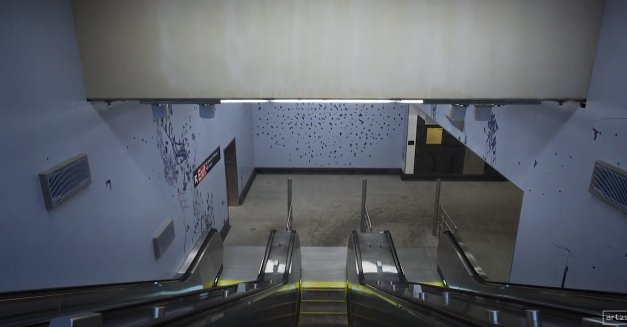Empty parking garage viewed from a car, with ramps and walls ahead.