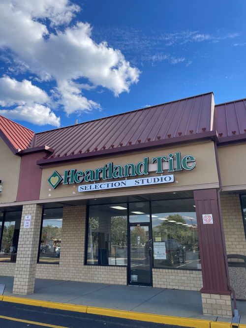 Heartland Tile Selection Studio storefront with red roof and blue sky above