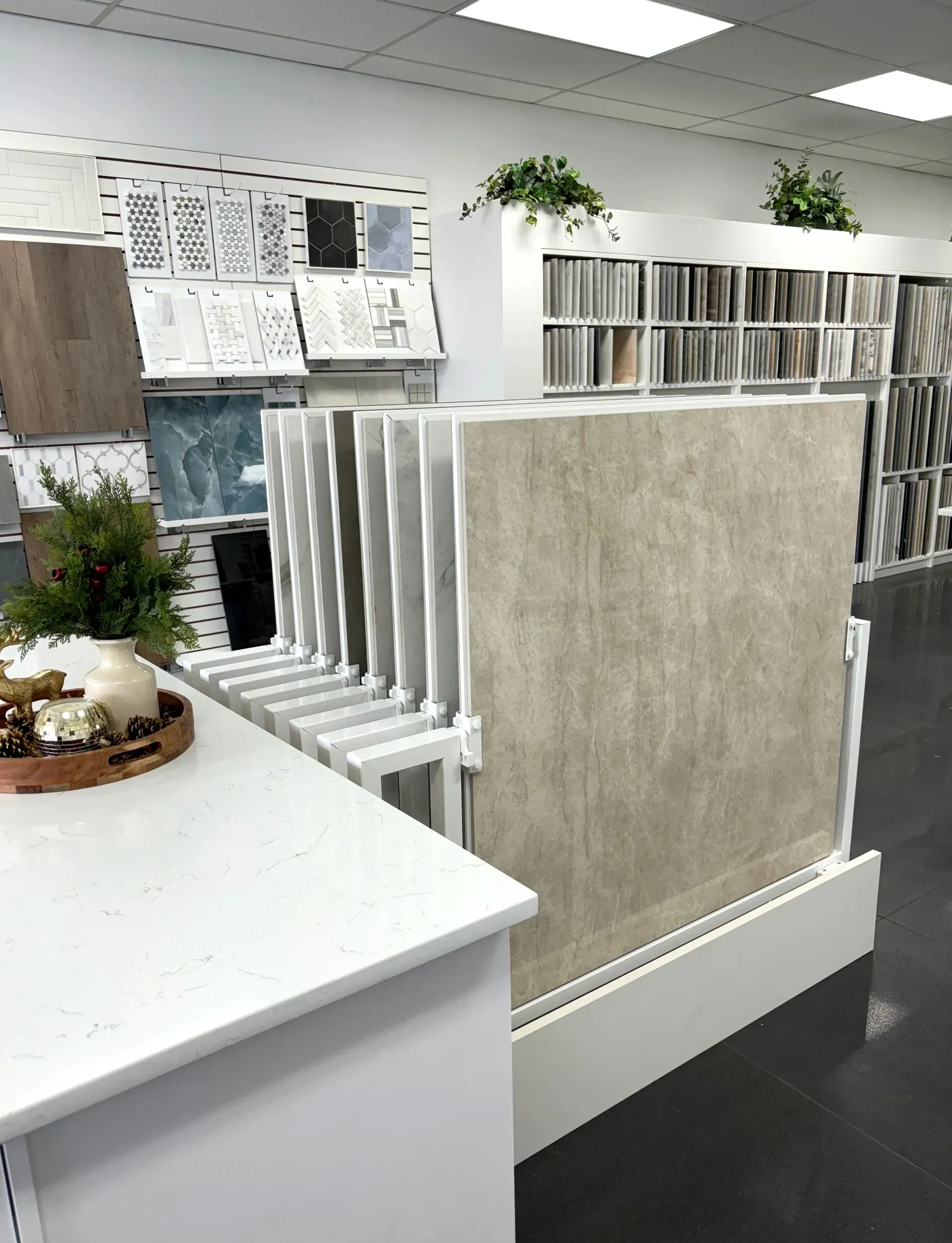 Flooring and tile showroom with display racks of sample sheets and carpet panels