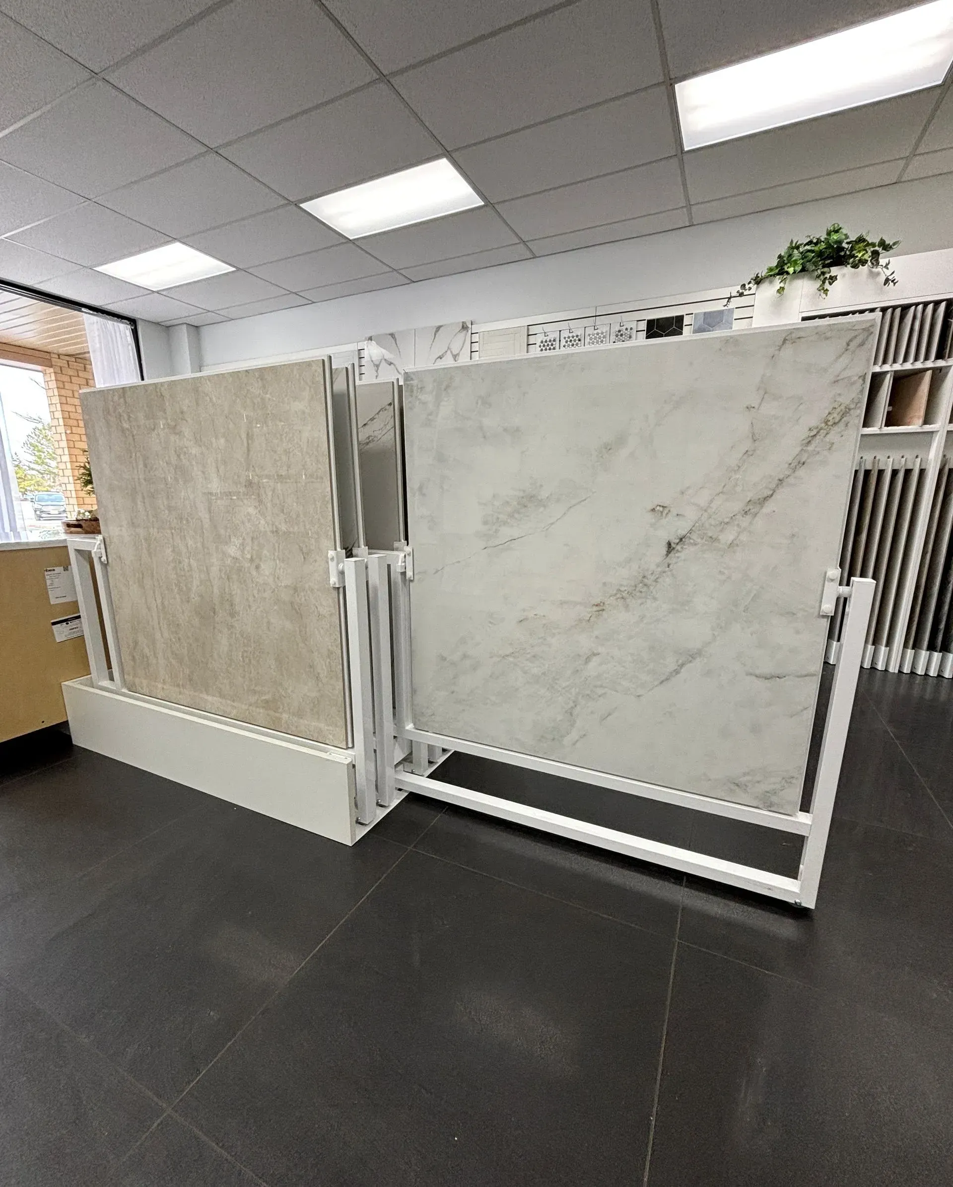 Tile and stone sample display in an office showroom with bright overhead lights