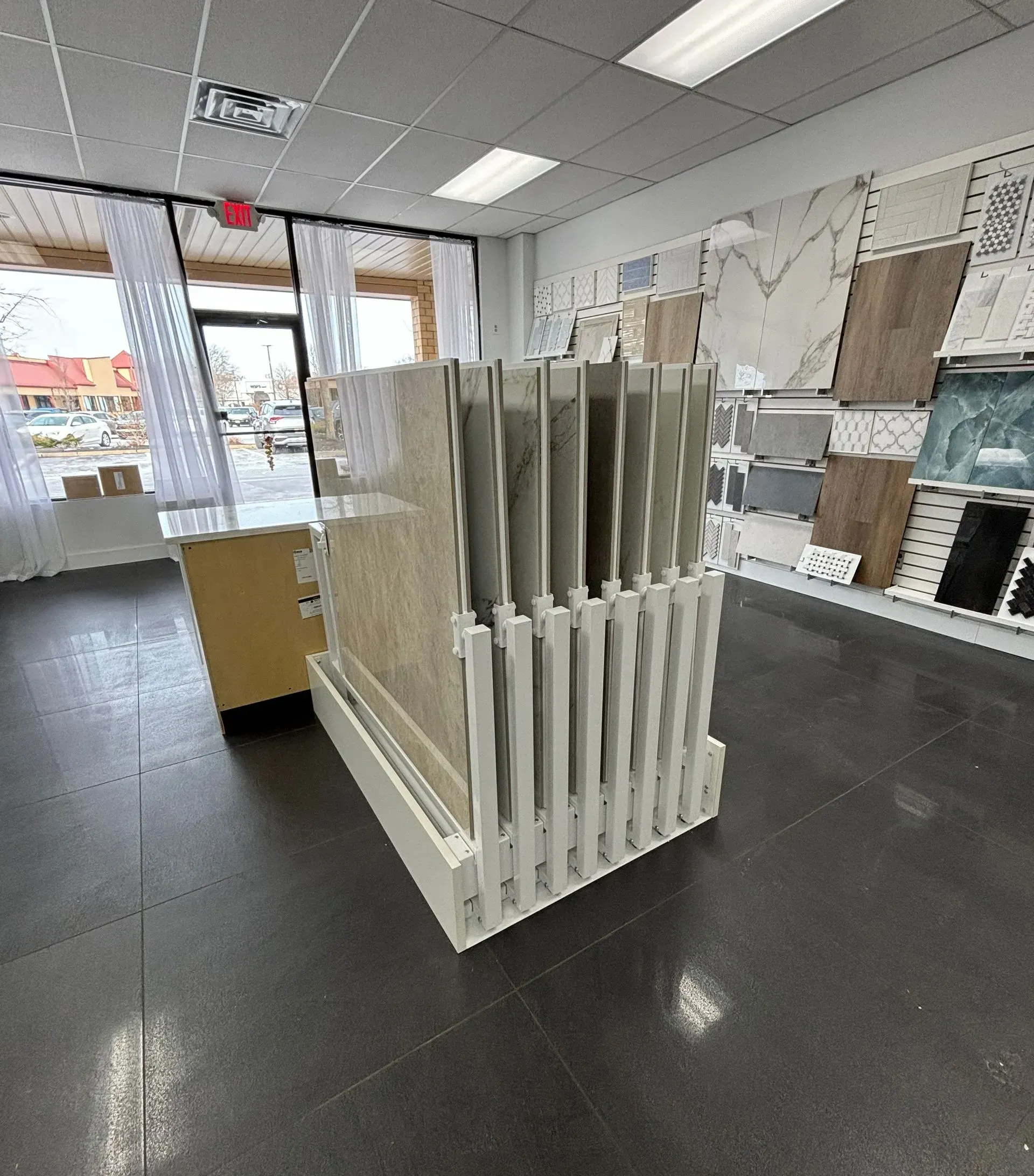 Tile display rack in a store showroom with sample tiles and flooring displays.