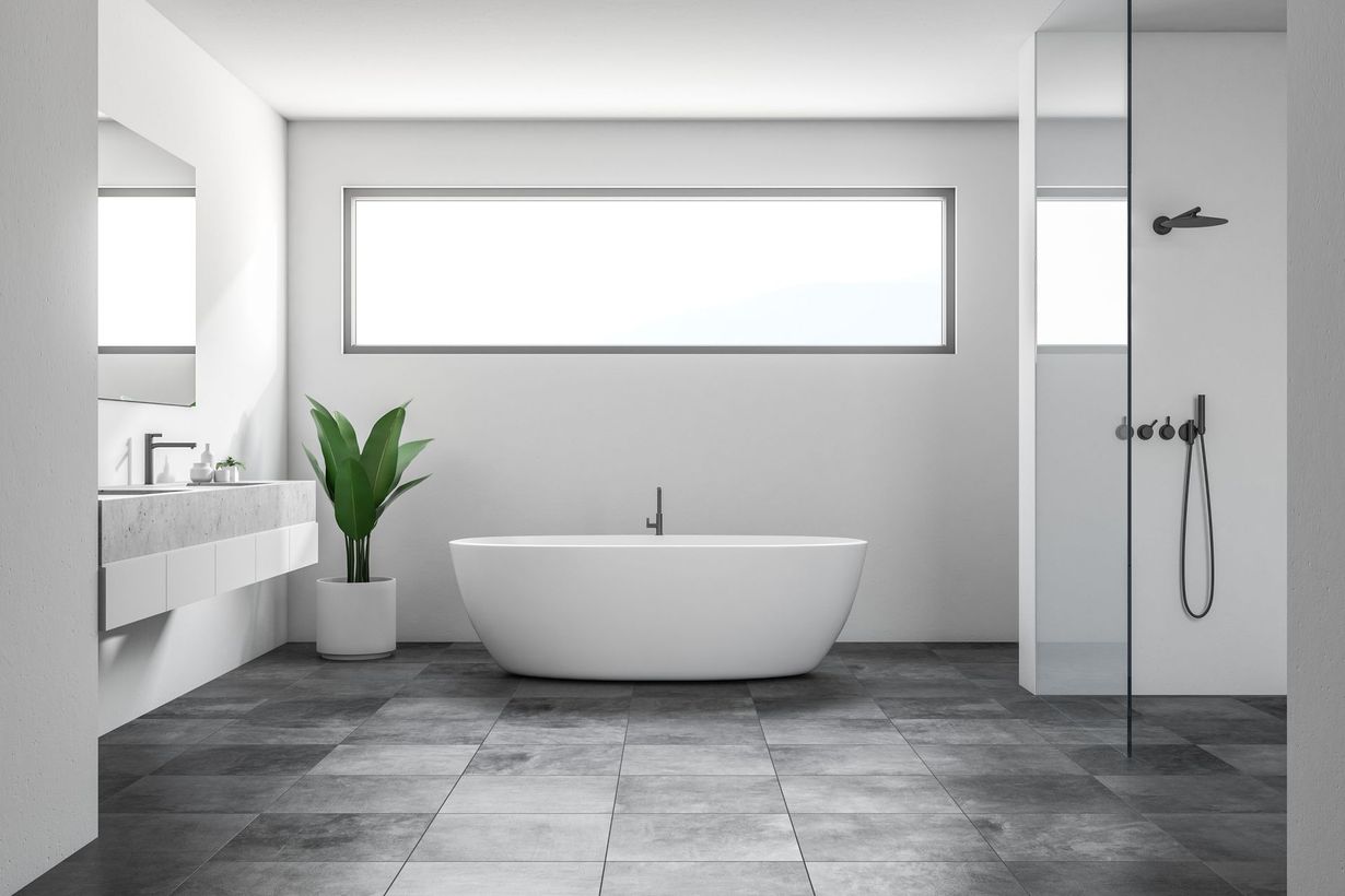 Modern minimalist bathroom with a freestanding tub, gray tile floor, and large window