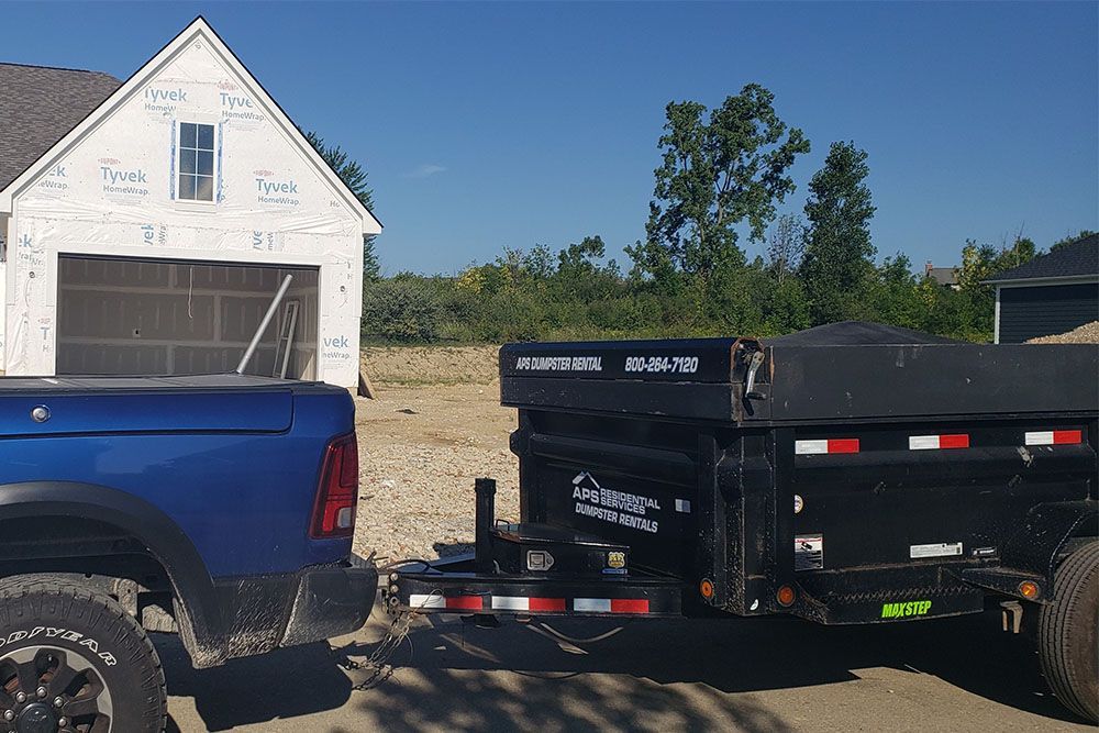 Blue Pickup with the APS Residential Services dumpster trailer