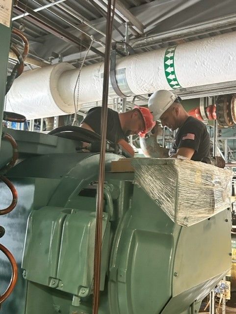 machine with two people at the back fixing it