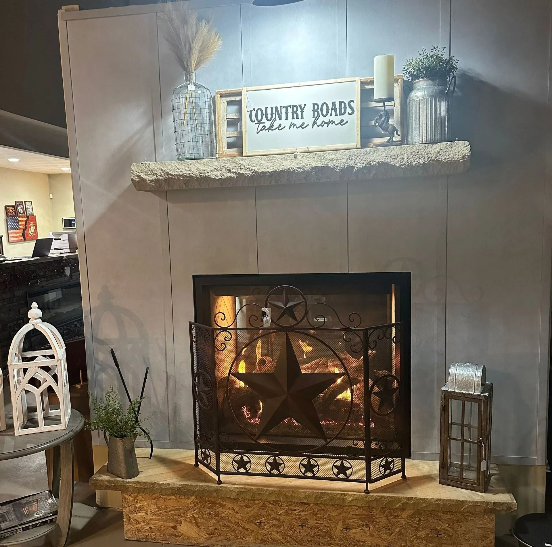 Fireplace with decorative star screen, mantle with decor, and