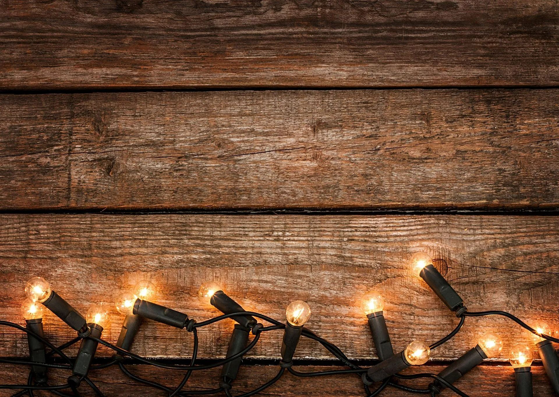 Wooden background with string lights along the bottom.