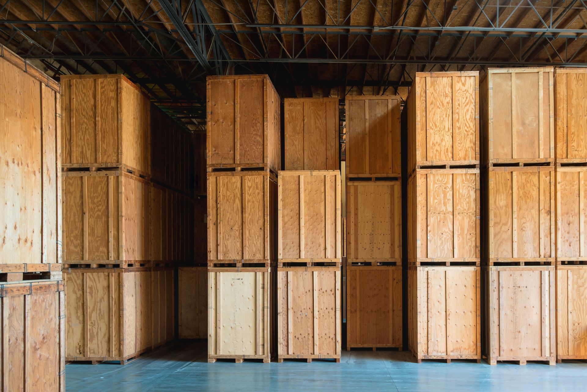 A warehouse filled with lots of wooden boxes stacked on top of each other.