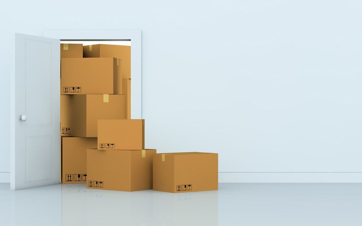 Boxes stacked in front of a blue wall 