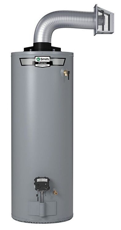 Tall, cylindrical gray water heater with vent pipe connected to a wall-mounted outlet.