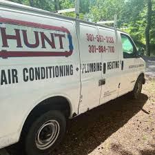 White van with phone numbers on the side.