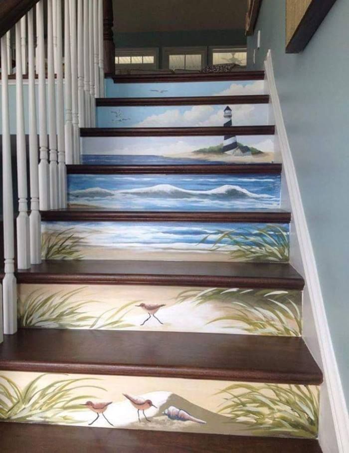 Staircase with painted ocean scenes on each step, featuring waves, birds, and grassy shorelines.