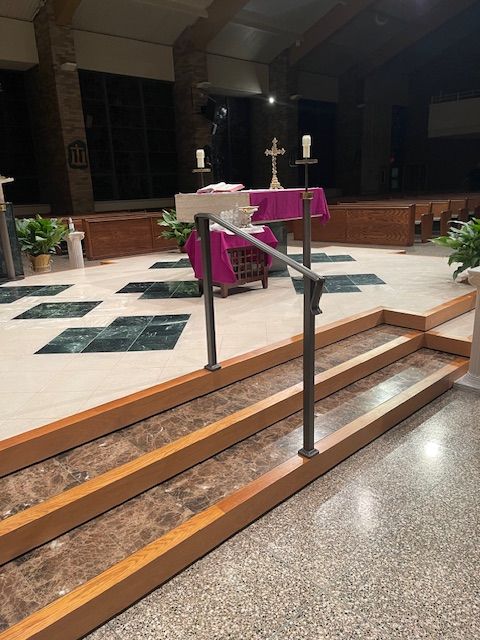 A church with a purple table and a cross on the altar