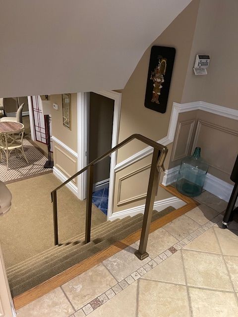 A view of a staircase from the second floor of a house.
