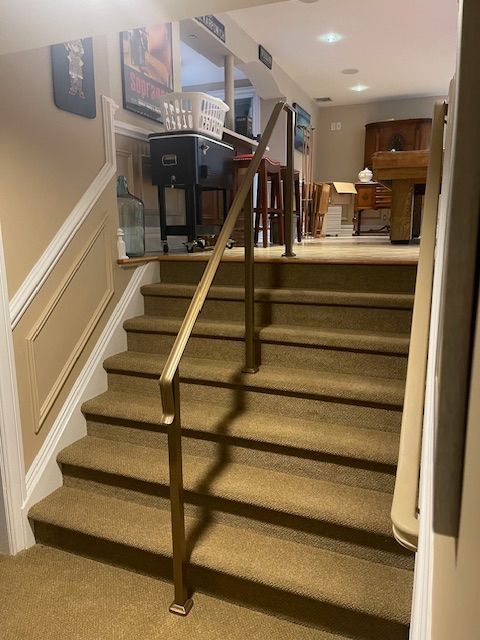 A set of stairs leading up to a room with a pool table
