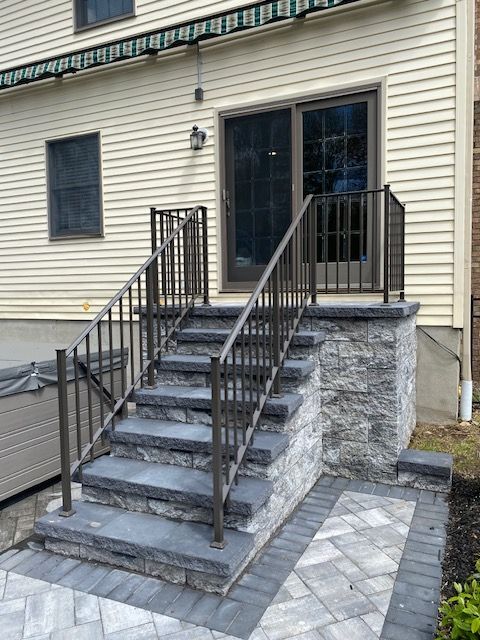 A set of stairs leading up to a house with a railing