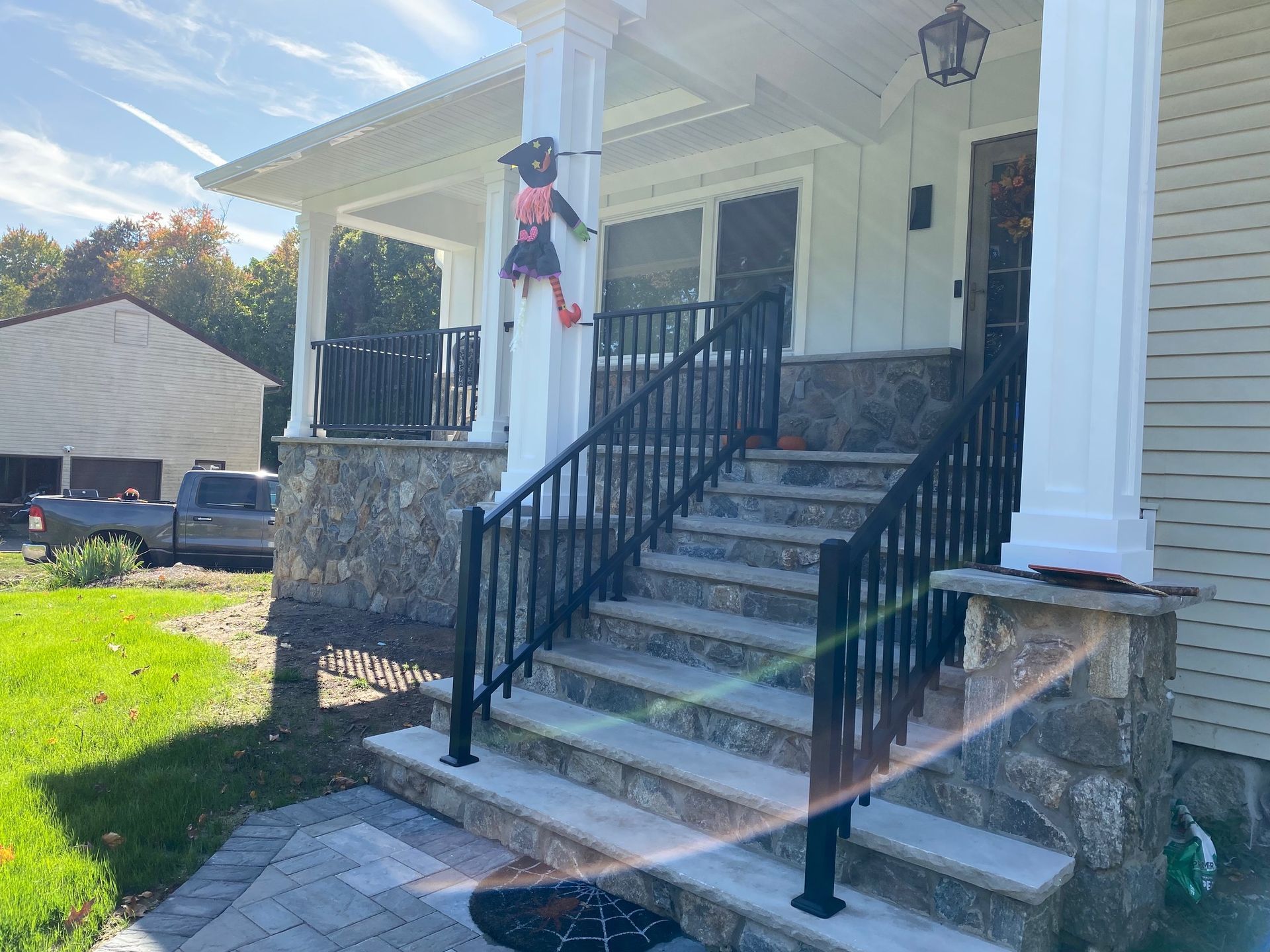 A house with a porch and stairs decorated for halloween