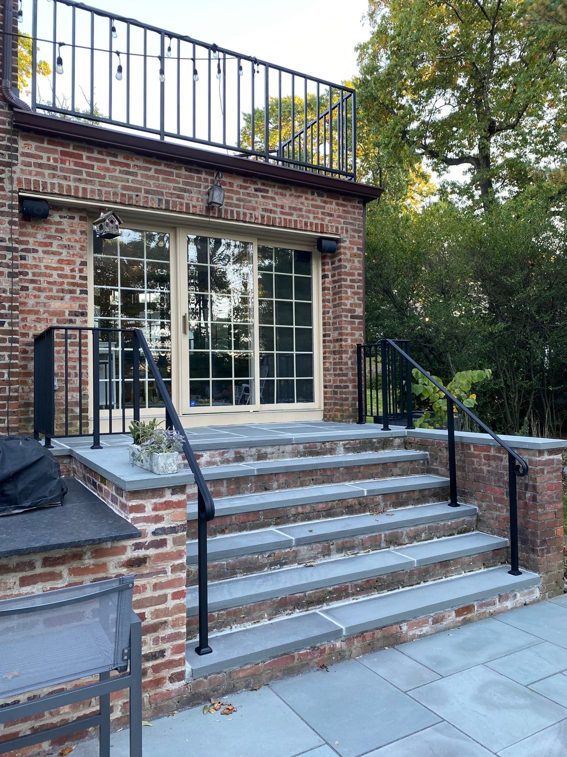 A brick building with a balcony and stairs leading up to it.