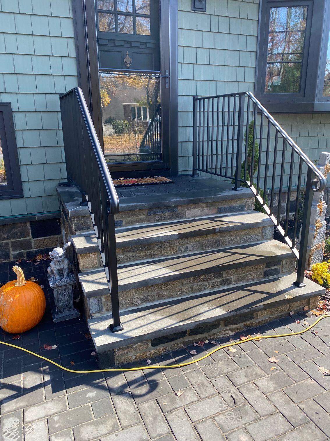 A set of stairs leading up to the front door of a house.