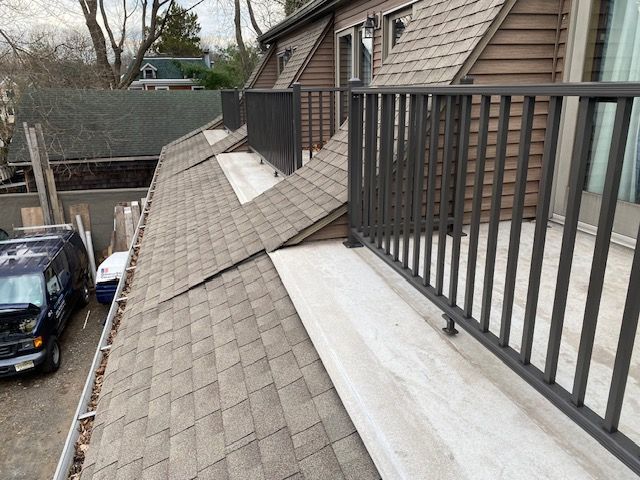 A balcony with a railing on the side of a house