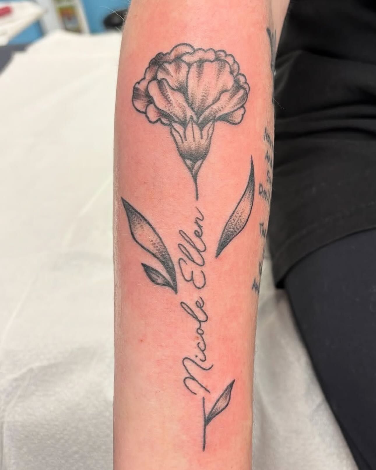 Black and white tattoo of a carnation
