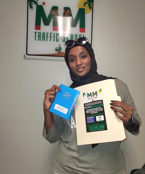 Woman in hijab holds book and folder in front of
