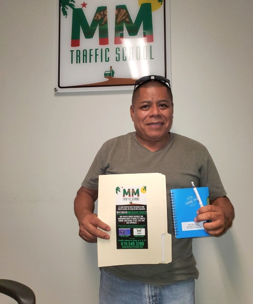 Man holding folder and notepad in traffic school office.