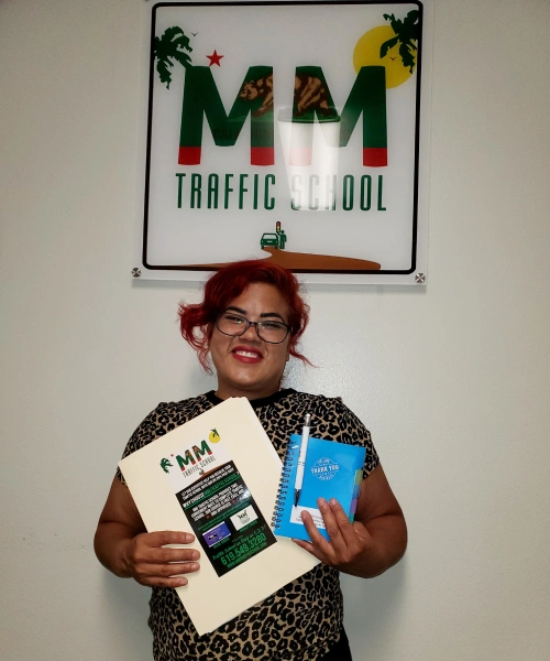 Woman with red hair holds folder and notebook in front of