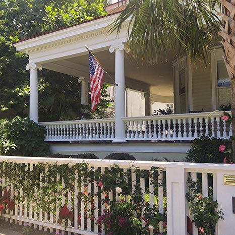 An american flag is flying on the porch of a house