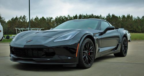 A black corvette zr1 is parked in a parking lot.