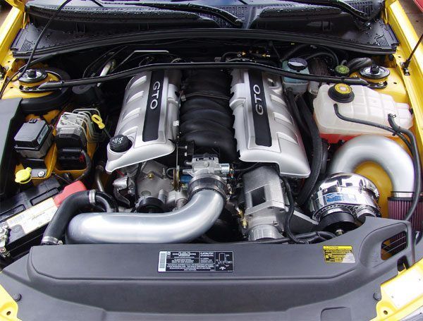 The engine of a yellow gto car is shown