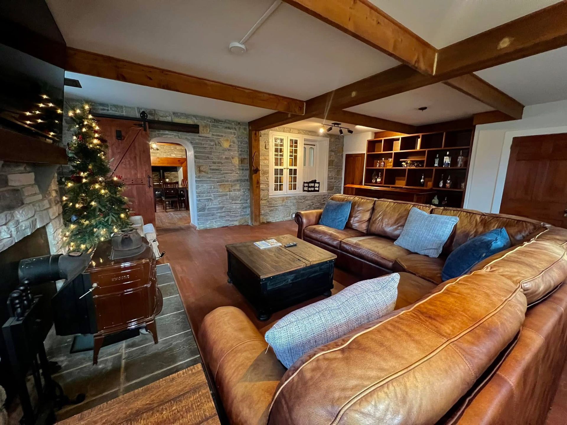 A living room filled with furniture and a christmas tree.