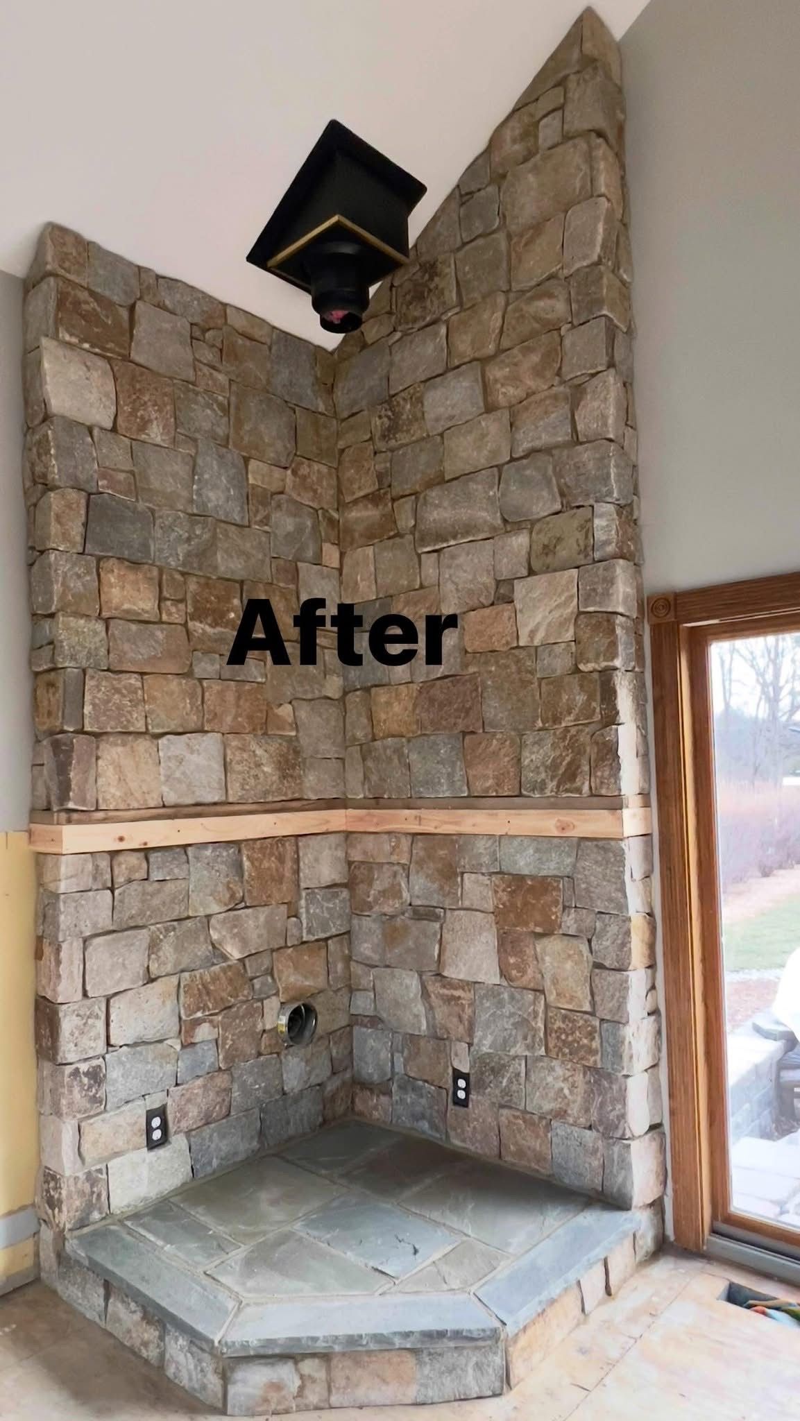 A stone fireplace in a living room with the words `` after '' written on it.